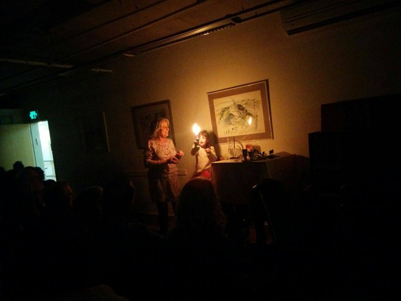 woman and child lighting candles at Reform service in Israel