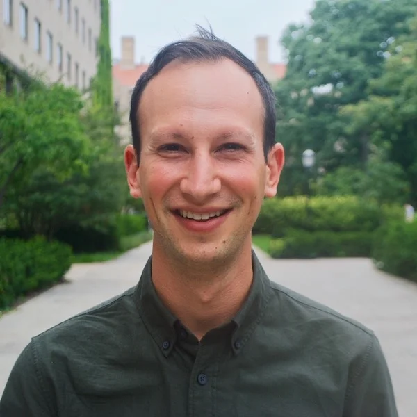 smiling man on a college campus