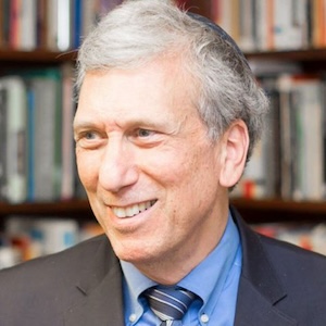 grey-haired man wearing suit and yarmulke