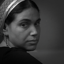 Headshot photograph of woman wearing head covering.