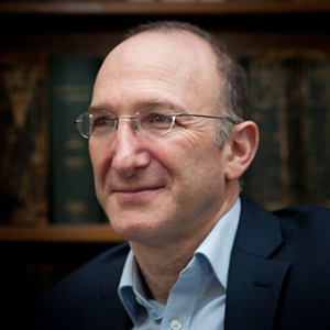 headshot of man wearing rimless glasses