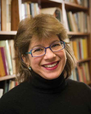 headshot of woman wearing rectangular glasses and a turtleneck