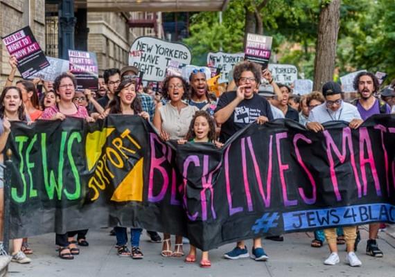 picture of people holding a banner saying "Jews Support Black Lives Matter"