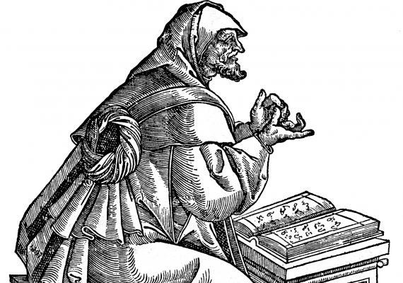 woodcut illustration of seated scholar with open book
