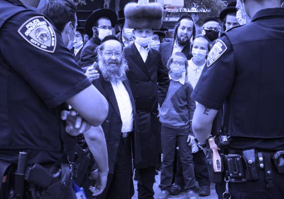 Photograph of members of the Orthodox Jewish community facing NY police officers