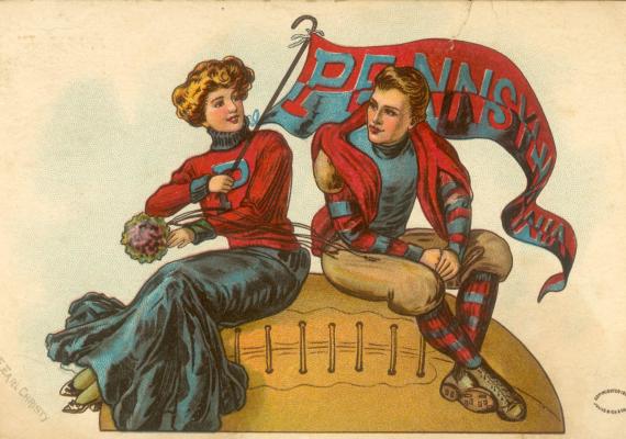 A color print depicting a young white woman and man seated on an oversized football. They wear Penn colors and the woman holds a large pennant flag.