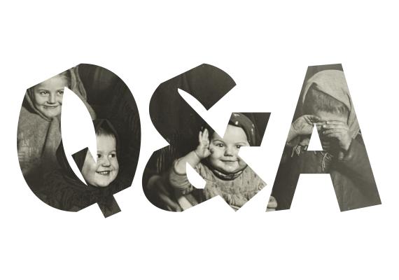 Visible through the letters Q and A is a photograph of three smiling and one crying child, all wearing head coverings.