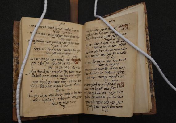 Book open to handwritten Hebrew text.