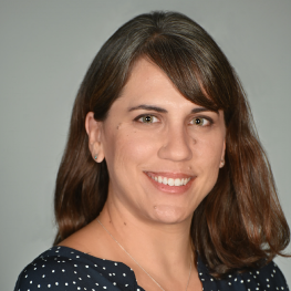 Woman with shoulder-length hair looks directly at the viewer