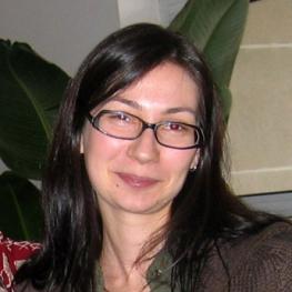 Snapshot photograph of smiling woman with long, straight hair.