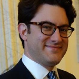 Snapshot photograph of man wearing a suit and tie.