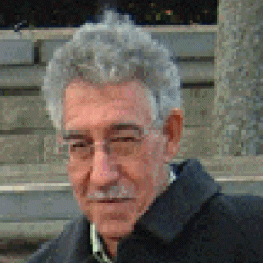 Photograph of older man with thick, grey hair and a mustache.