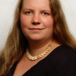 Headshot photograph of a woman with long hair.