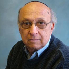 Headshot photograph of elderly man wearing glasses and a yarmulke.